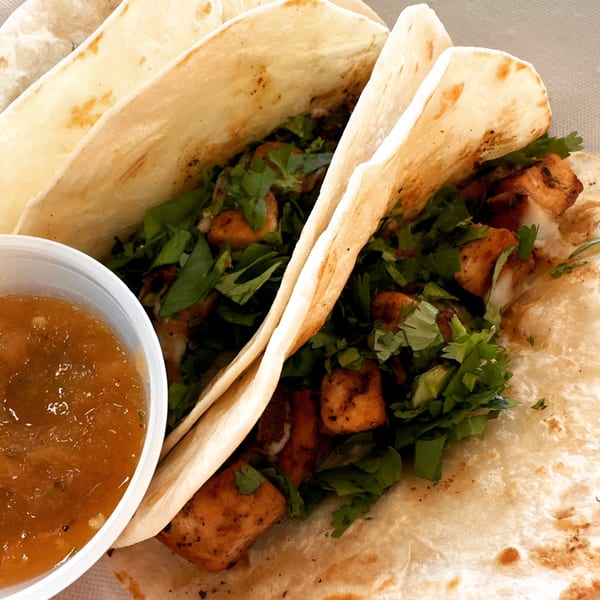 Three healthy Fit Factory Grill tacos filled with chicken and cilantro, with a side of salsa.